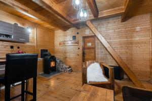 a room with a wood paneled wall with a stove at Wellness chata Sloupnice in Sloupnitz