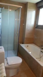 y baño con ducha, aseo y bañera. en Chalet en Somió con finca independiente en Gijón
