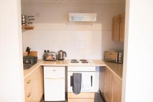 a small kitchen with a white stove top oven at Lovely 1 bedroom Apartment High Wycombe in Buckinghamshire