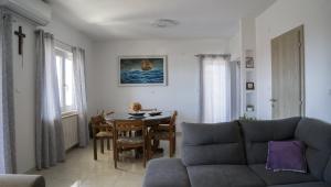 a living room with a couch and a table at Apartments Bazina in Kaštela