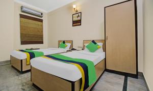 Postel nebo postele na pokoji v ubytování Treebo Maharaja Residency Family Hotel