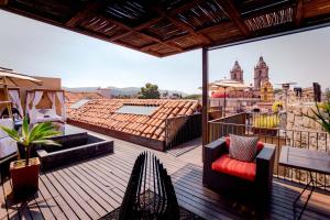 a balcony with a view of a city at Múbú Hotel Boutique in Valle de Bravo