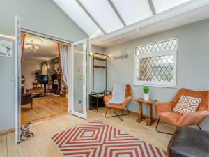 a living room with a couch and chairs and a window at Featherstone House in Heighington