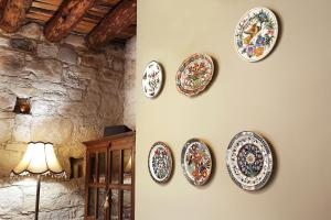a group of plates hanging on a wall at KANTARA HOUSE - A Rural Retreat of Comfort & Class! in Arsos