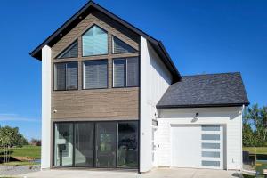 a house with a white garage and a black roof at Brand New Red Lodge Home with Private Hot Tub! in Red Lodge