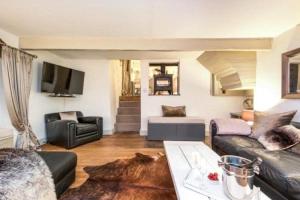 a living room with a couch and a table at Dreamwood Cottage Luxury Hottub Retreat in Crigglestone