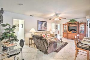 a living room with a couch and a table at Cape Coral Home with Gulf and Dock Access in Cape Coral