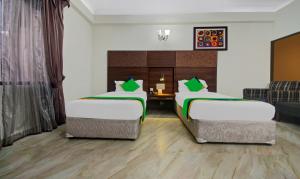 Postel nebo postele na pokoji v ubytování Treebo Maharaja Residency Family Hotel