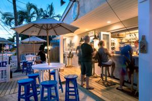 a group of people standing outside of a restaurant at Southwinds Motel in Key West