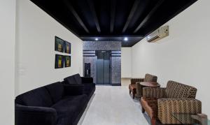 a living room with black ceilings and couches at Treebo Trend Maharaja Residency in Jaipur