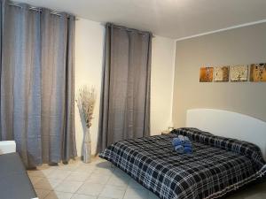 a bedroom with a bed with a black and white blanket at Civico 2 in Sassari