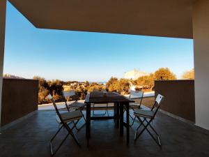 a table and chairs on a patio with a view at Casa Alexandra in Castelsardo