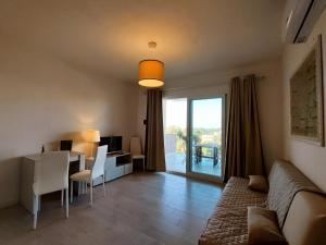 a living room with a table and a dining room at Casa Alexandra in Castelsardo