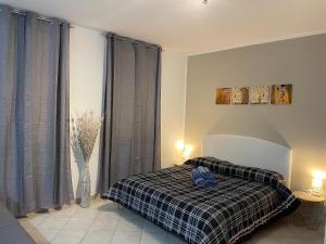 a bedroom with a bed with a plaid blanket at Civico 2 in Sassari