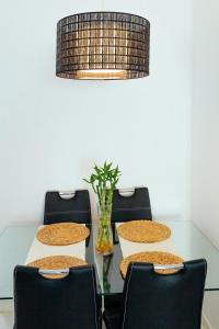 a dining room table with chairs and a lamp at Apartment with a patio in Las Canteras in Las Palmas de Gran Canaria