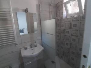 a white bathroom with a sink and a mirror at Albergo Abruzzese in Riano
