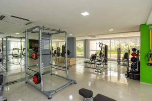 a gym with several tread machines in a room at The Expression 112 in Goiânia