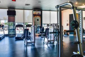 a gym with rows of treadmills and machines at Wonderful Studio Beachwalk with Great Views in Hallandale Beach