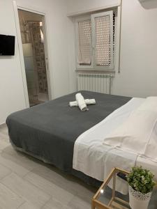a bedroom with a large bed with two towels on it at Albergo Abruzzese in Riano +6 photos