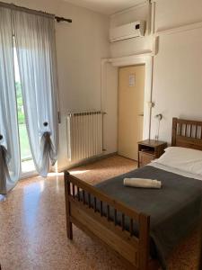 a bedroom with a bed and a large window at Albergo Abruzzese in Riano