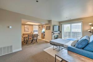 a living room with a blue couch and a table at Park City Condo with View - Walk to ShopsandDining in Park City