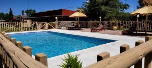 a swimming pool in a yard with a fence at Rincón Azul in San Rafael