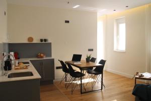 a kitchen with a table and chairs with a laptop on it at Hotel Boutique Astorga in Valladolid