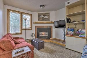 a living room with a couch and a fireplace at Iron Horse Studio with Resort Amenities Walk to WP! in Winter Park