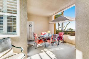 a dining room with a table and chairs and a window at Ocean Pointe Lagoon 121 in Carlsbad