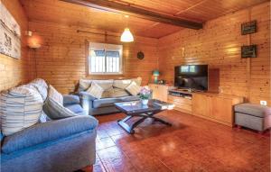 a living room with couches and a tv and a table at Awesome Home In Molina De Segura With Kitchen in Molina de Segura