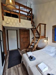 a bedroom with two bunk beds and a staircase at Máttaráhkká Northern Light Lodge in Kiruna