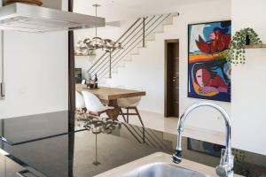 a kitchen with a sink and a dining room at Casa Amour Villa in Lourinhã +36 photos