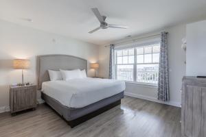 a bedroom with a large bed and a window at Impala Suites in Ocean City