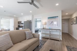 a living room with a couch and a kitchen at Impala Suites in Ocean City