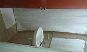 a bathroom with a white toilet and a sink at La Celmira in Concordia