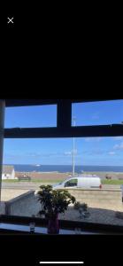 a window with a view of an airport with a van at Moray View, Macduff, Aberdeenshire. in Macduff