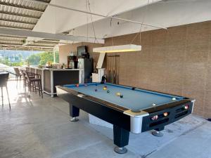 a pool table in the middle of a room at Victoria's Bed & Breakfast in Puerto Galera