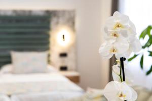 Łóżko lub łóżka w pokoju w obiekcie Laguna Home & Suites