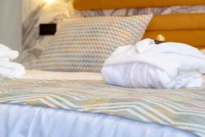 Łóżko lub łóżka w pokoju w obiekcie Laguna Home & Suites