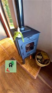 a blue stove sitting on top of a wooden floor at Casa de Montaña Tica Linda in Monteverde Costa Rica