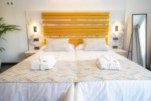Łóżko lub łóżka w pokoju w obiekcie Laguna Home & Suites