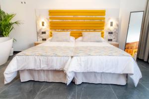 Łóżko lub łóżka w pokoju w obiekcie Laguna Home & Suites