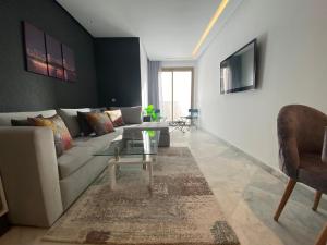 a living room with a couch and a table at CORNICHE CASABLANCA - SUBLIME F2 NEUF in Casablanca