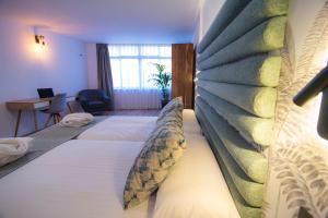 Łóżko lub łóżka w pokoju w obiekcie Laguna Home & Suites