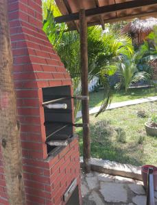 a brick oven in the side of a house at Safira Beach House in Pipa