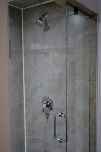a shower with a glass door in a bathroom at Beautiful and spacious Apartment in Brampton