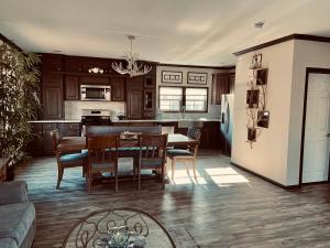 a kitchen and living room with a table and chairs at Swan Lake Resort in Galloway