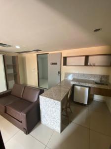 a kitchen with a couch and a table in a room at Imperial Suites in João Pessoa