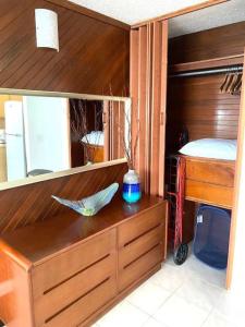 a bedroom with a wooden closet with a bed and a desk at KASA Emmas Ocean View in San Juan