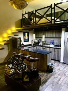 a large kitchen with a counter and a refrigerator at Independencia Dos 7 Hotel Boutique in Querétaro